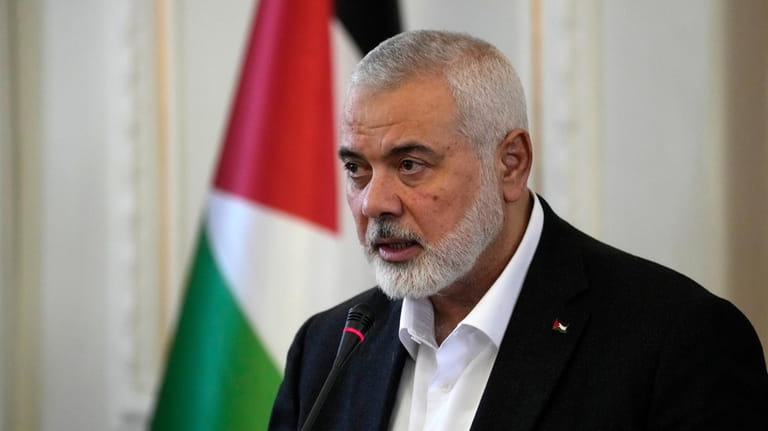 Hamas chief Ismail Haniyeh speaks during a press briefing after...