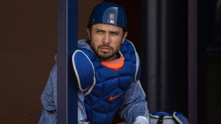 Mets catcher Travis d'Arnaud looks on during a spring training...
