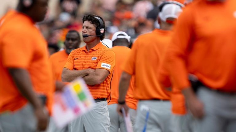 Oklahoma State head coach Mike Gundy stands on the sideline...