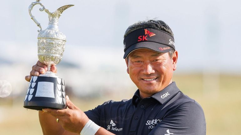 K.J. Choi poses with the Claret Jug after winning The...