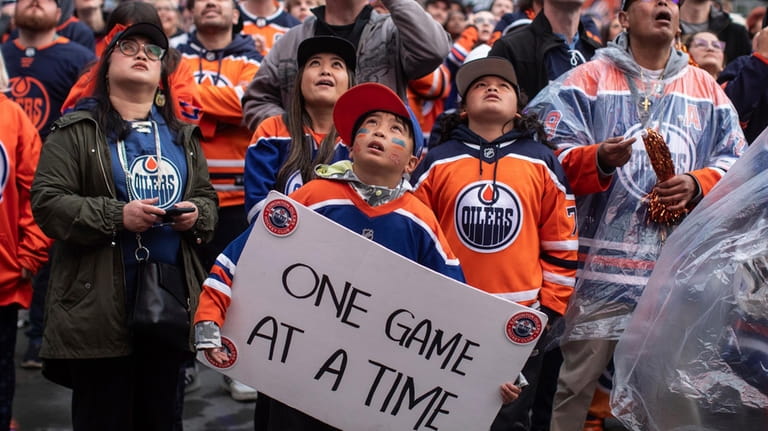 Edmonton Oilers fans watch coverage of Game 5 of the...