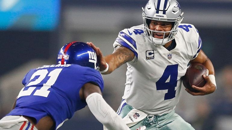 Cowboys quarterback Dak Prescott runs against Giants' Landon Collins in the first...