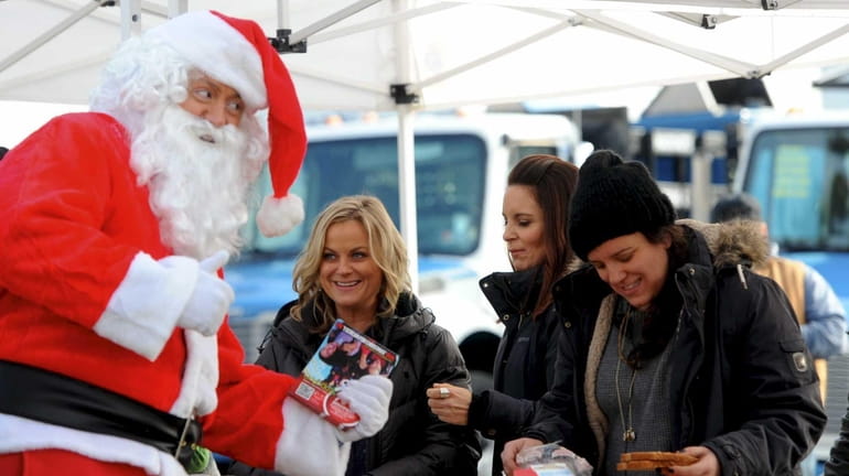 Amy Poehler and Tina Fey with Santa Claus on the...