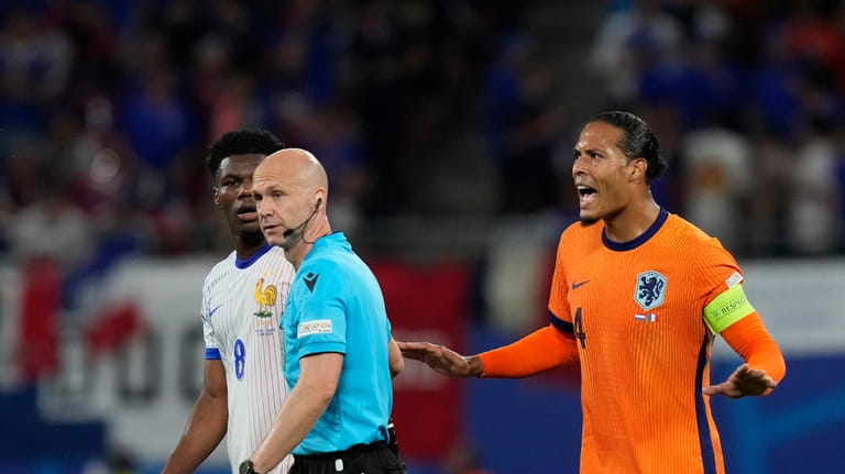 Virgil van Dijk of the Netherlands, right, protest to the...