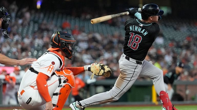 Arizona Diamondbacks' Kevin Newman (18) watches his two-run single in...