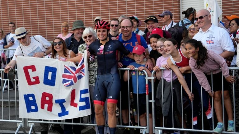 Britain's Sarah Storey celebrates with fans after winning the gold...