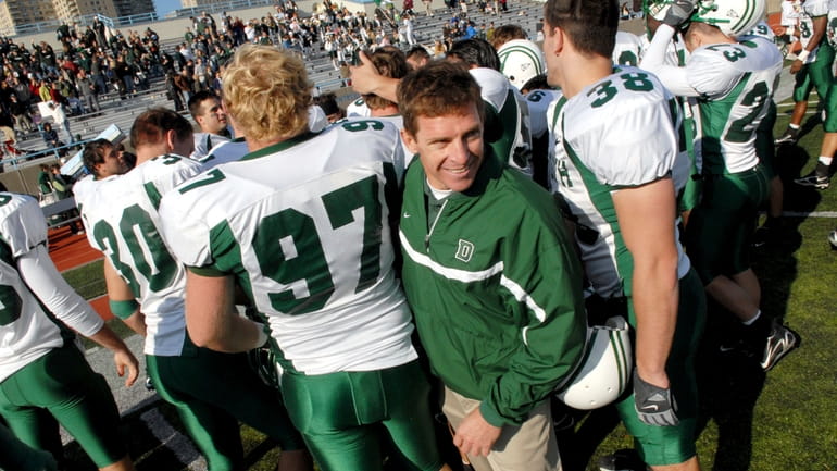 Dartmouth coach Buddy Teevens celebrates with the team after a...