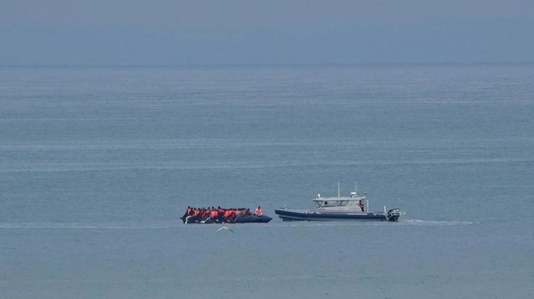 A boat thought to be with migrants is escorted by...