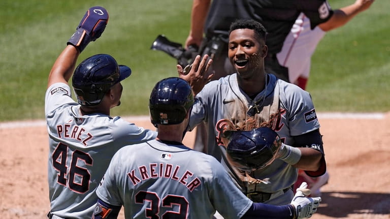 Detroit Tigers' Justyn-Henry Malloy, right, celebrates with Wenceel Perez, left,...