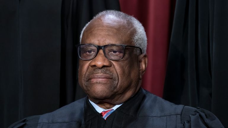 Associate Justice Clarence Thomas joins other members of the Supreme...