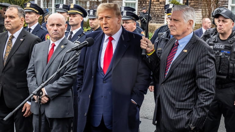 Former President Donald Trump, center, attends the wake for NYPD...