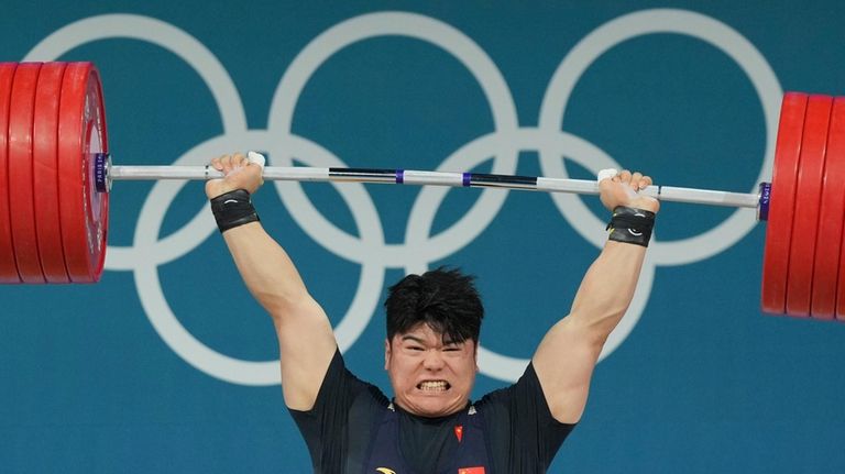 Liu Huanhua of China competes during the men's 102kg weightlifting...