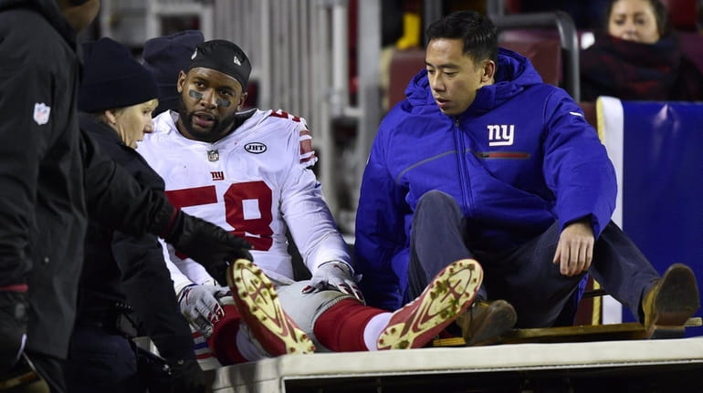Curtis Grant of the Giants is carted off the field...