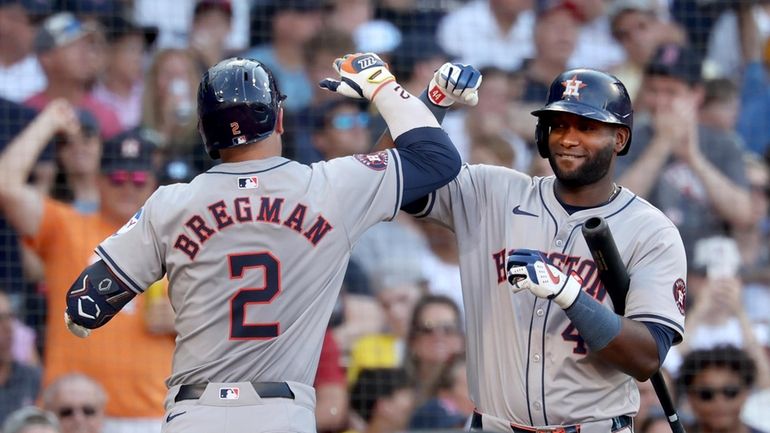 Houston Astros hitter Alex Bregman, left, celebrates after his home...