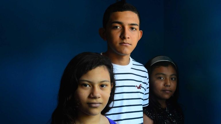 (L-R) Anyeli Rojas, 13, her brother Saul Martinez, 15 and...