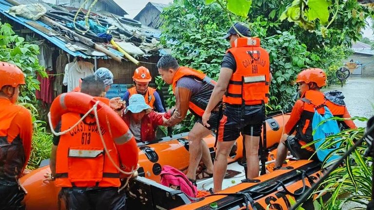 In this photo provided by the Philippine Coast Guard, rescuers...