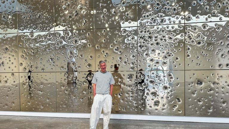 Italian artist Maurizio Cattelan poses with his installation, "Sunday," at...