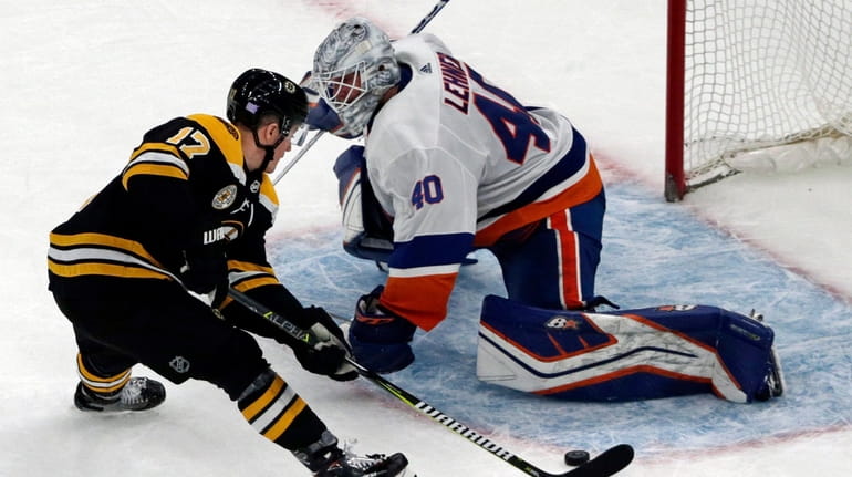 Bruins center Ryan Donato scores against Islanders goaltender Robin Lehner during a...