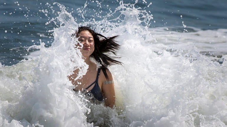 Flushing resident Kelly Leem, 19, enjoying the rough surf at...