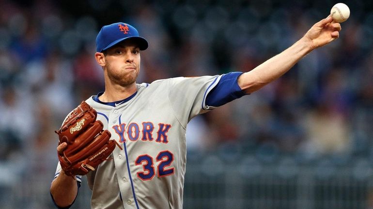 Mets starting pitcher Steven Matz throws to first to hold...