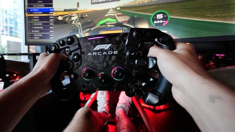 Caua Berger, of Revere, Mass. drives a race simulator at...