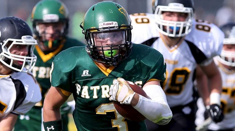 Ward Melville's Eddie Munoz returns the kickoff for 30 yards...