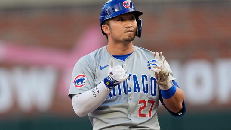 Chicago Cubs' Seiya Suzuki reacts after hitting a double in...