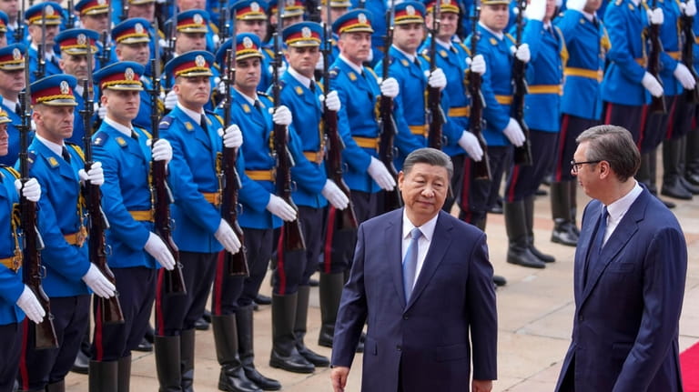 Chinese President Xi Jinping, left, reviews an honor guard with...