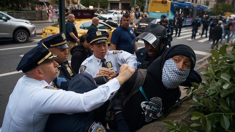 Police arrest a pro-Palestinian protester near the Metropolitan Museum of...