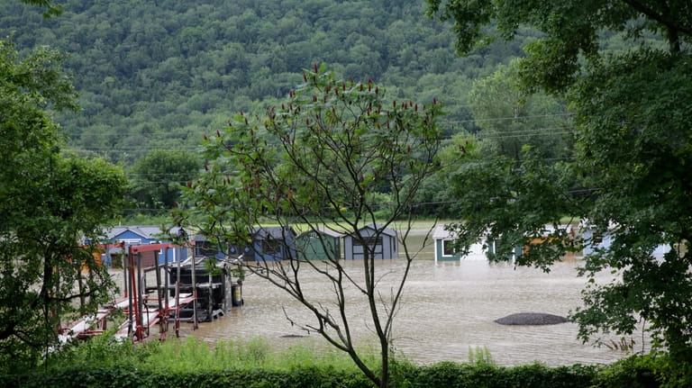 Water floods the lower level of homes, Thursday, July 11,...