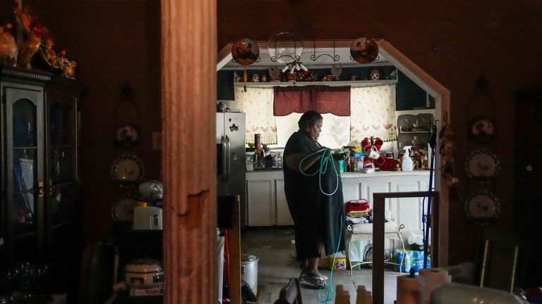 Shelia Mae Dobbins walks with her oxygen tube inside her...