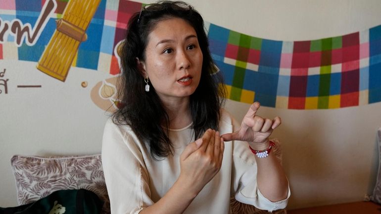 Chinese mother Du Xuan gestures during an interview with The...