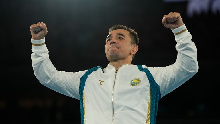 Gold medalist Uzbekistan's Hasanboy Dusmatov celebrates on the podium for...