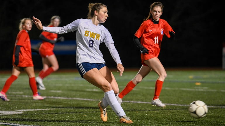 Shoreham-Wading River's Grace Hillis passes the ball during the state...