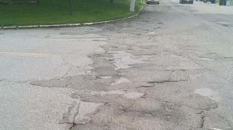 Rutted pavement at Eastwood Boulevard and Hawkins Road in Centereach...