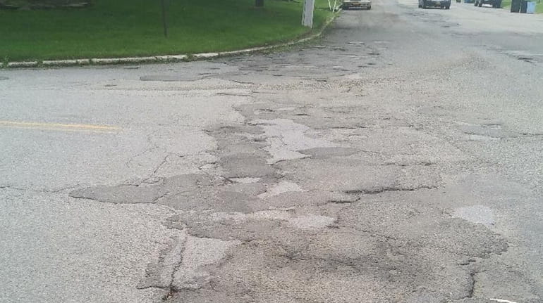 Rutted pavement at Eastwood Boulevard and Hawkins Road in Centereach...