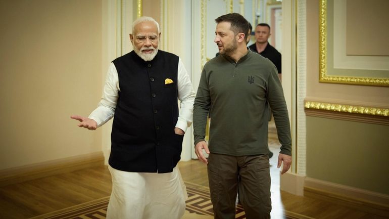 Indian Prime Minister Narendra Modi, left, is seem speaking with...