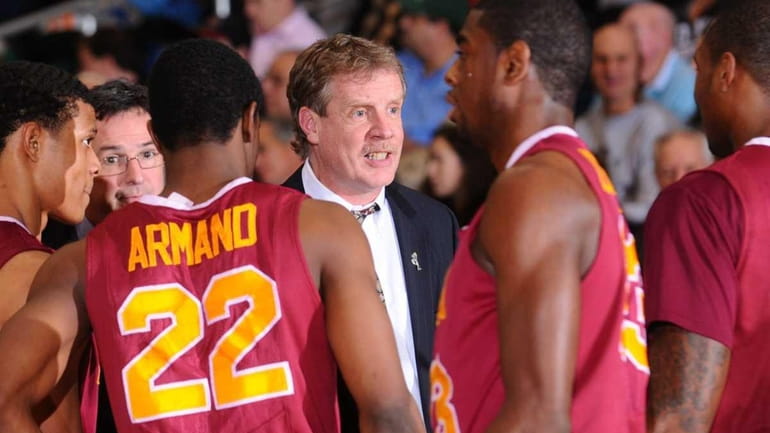 Iona College men's basketball head coach Tim Cluess talks to...