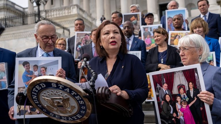 Sen. Tammy Duckworth, D-Ill., center, accompanied by Senate Majority Leader...