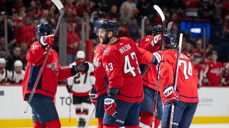 Washington Capitals celebrate after a goal by defenseman John Carlson...