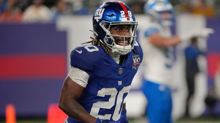 Giants running back Eric Gray reacts after scoring a touchdown...