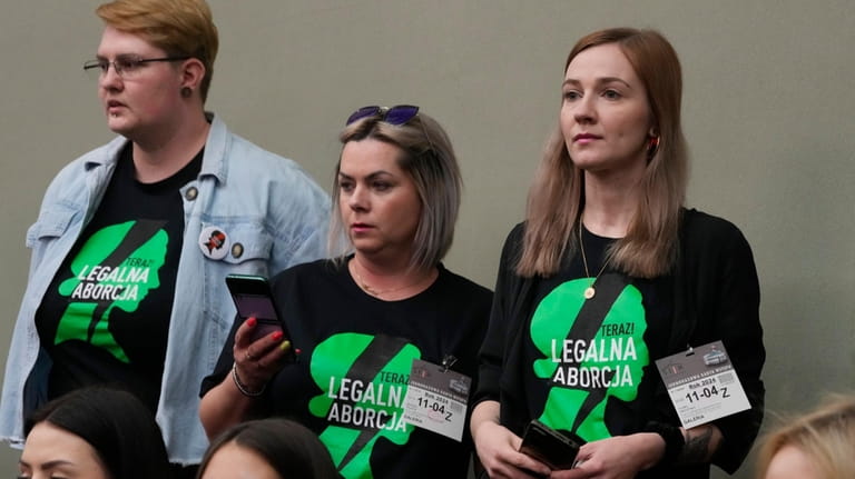 Abortion rights activists attend a debate in the Polish parliament...