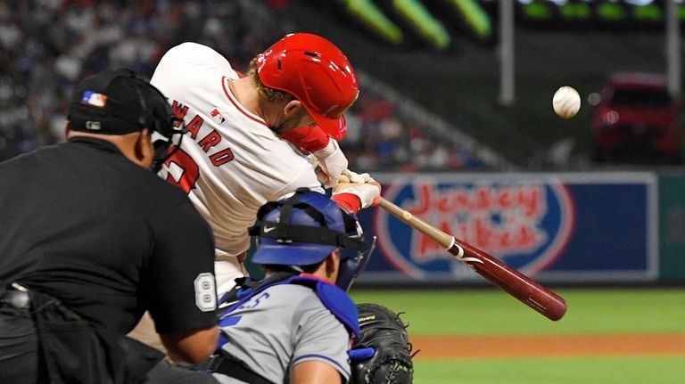 Los Angeles Angels' Taylor Ward, center, hits a solo home...