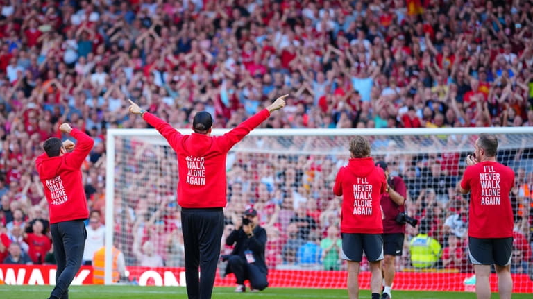 Liverpool's manager Jurgen Klopp reacts to fans after the English...