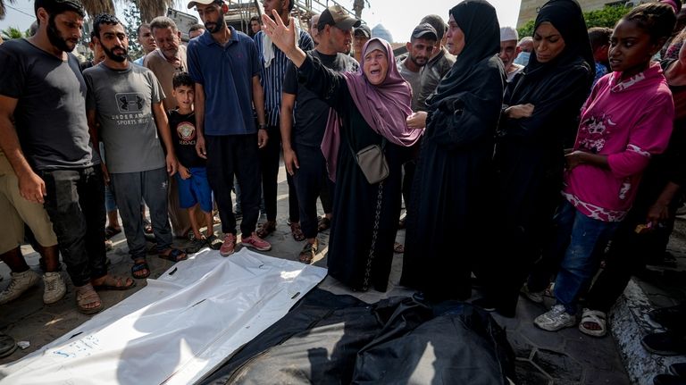 Palestinians mourn their relatives killed in the Israeli bombardment of...