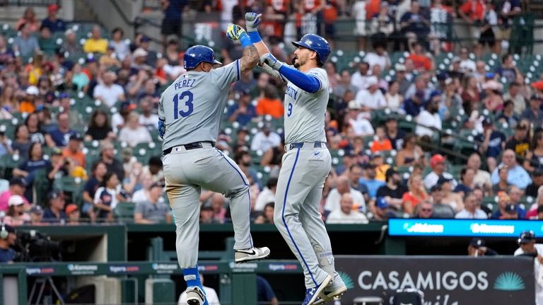 Kansas City Royals' Vinnie Pasquantino (9) is greeted by Salvador...