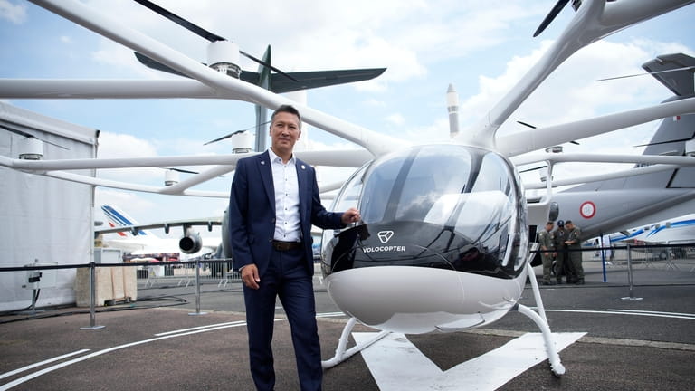 Volocopter CEO Dirk Hoke poses for a picture next to...
