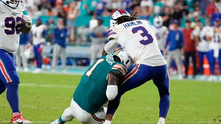 Miami Dolphins quarterback Tua Tagovailoa (1) collides with Buffalo Bills...