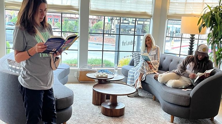 Book lovers in the lobby of the Lansby, a boutique hotel...