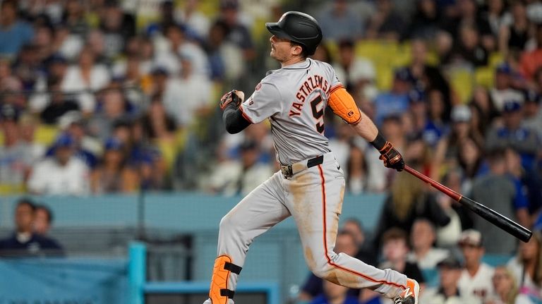 San Francisco Giants' Mike Yastrzemski hits a single to score...